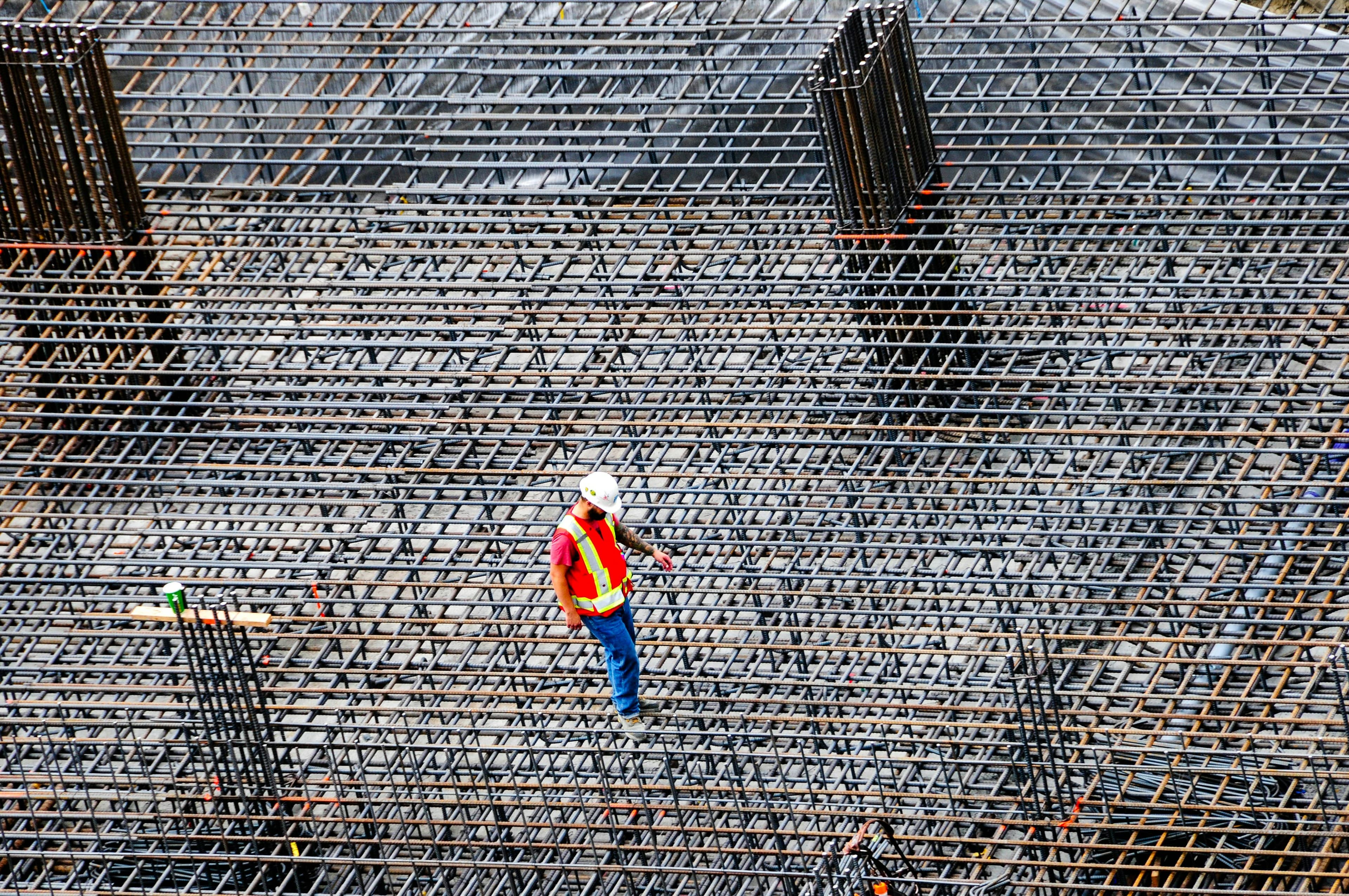 Ouvrier inspectant le ferraillage d'une dalle avant coulage